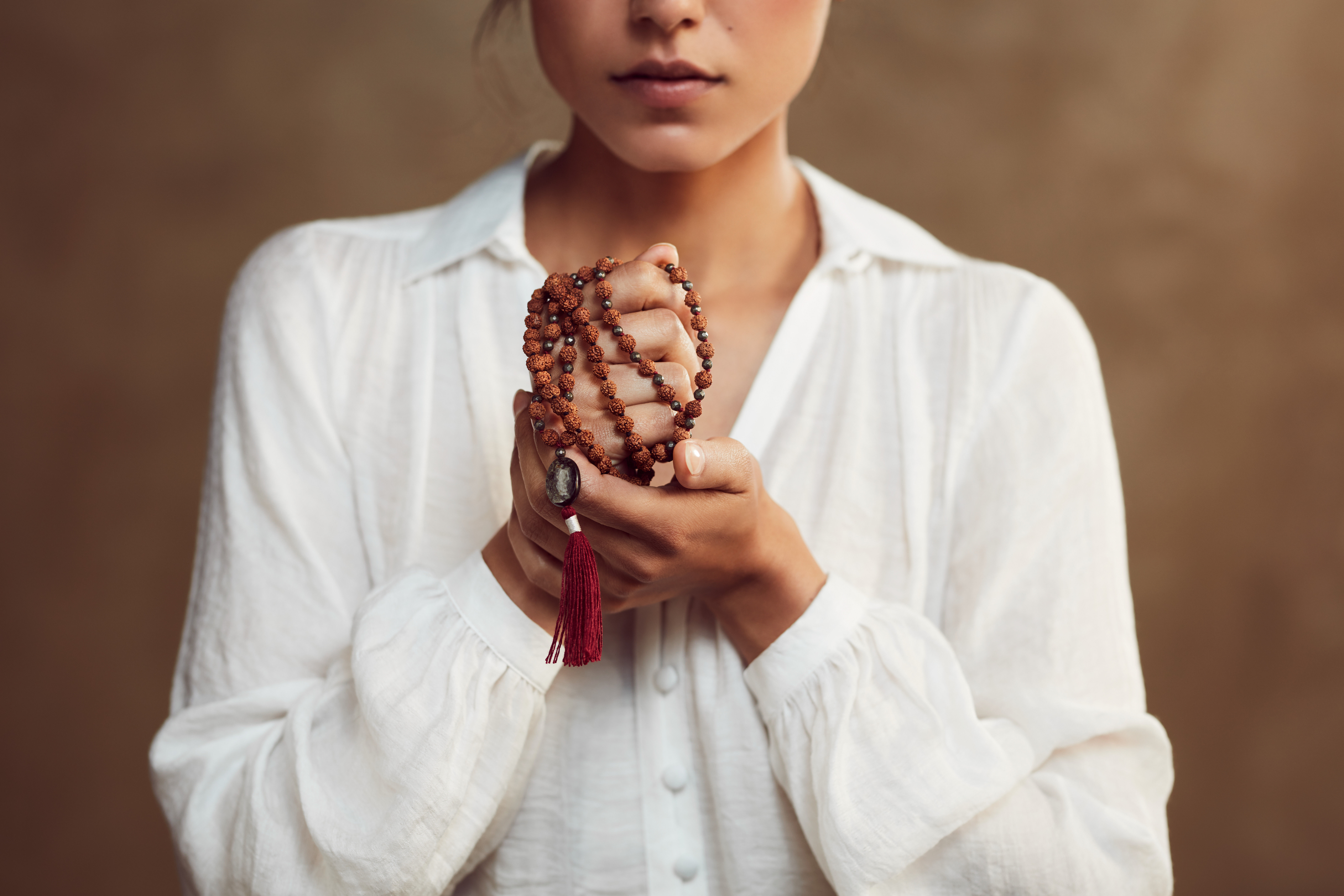 how to cultivate compassion, woman holding prayer beads